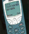Cell phone showing text messaging on its screen.