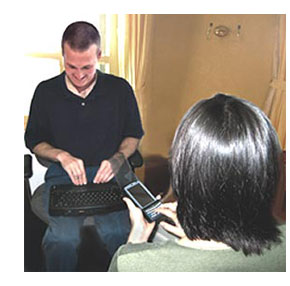 Picture of a deafblind individual communicating with a sighted campanion using FaceToFace